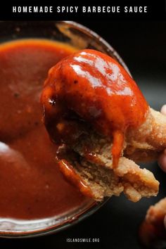 someone is dipping sauce into a bowl of barbecue sauce with a chicken nuggie