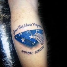 a person with a tattoo on their arm that says come but never forgotten, and an american flag in the background