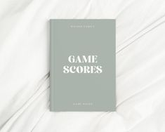 a book with the title game scores written in white on top of a bed sheet