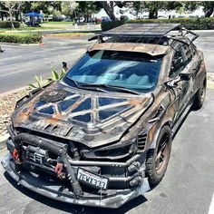 an old car that is parked on the side of the road with it's hood up