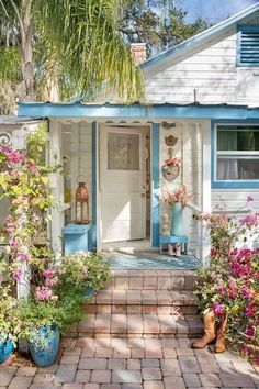 a house with flowers in the front yard and a quote about how to use it