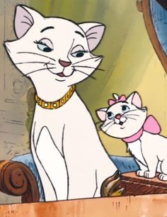 the cat and kitten are standing next to each other in front of an oval mirror