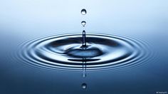 a water droplet is shown in the middle of a body of water with ripples