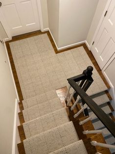 an overhead view of a stair case in a house with wood floors and white doors