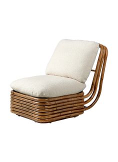 a chair made out of wicker with a cushion on the back and seat pad