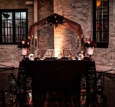 the table is set up with skulls and candles