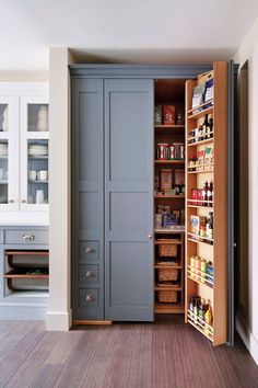 an open pantry door in the middle of a kitchen