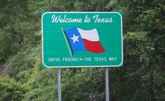 a welcome sign to the texas drive friend in the texas way, with trees in the background