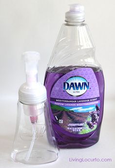 a bottle of dawn lavender liquid next to a dispenser on a white surface