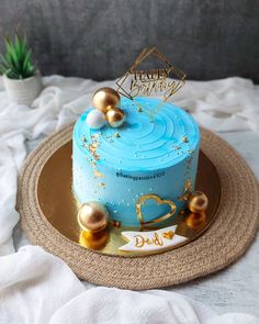 a blue and gold birthday cake on a plate