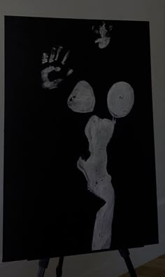 a black and white drawing of a person's hand and foot prints on a canvas