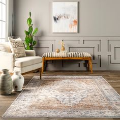 a living room with a couch, chair and coffee table in front of a painting on the wall