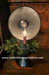 a table with a lamp on top of it next to a vase filled with flowers