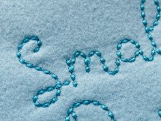 the word snow spelled out in blue yarn