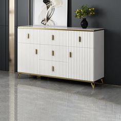 a white and gold dresser in a room