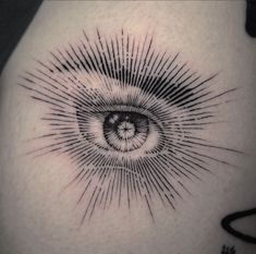 a black and white photo of an eye tattoo