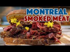 there is a sandwich with meat on it and the words montreall smoked meat