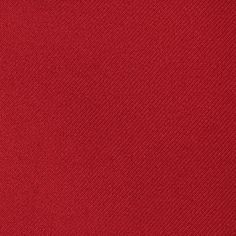 a red fabric textured with small white stitching on the bottom half of it