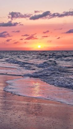 the sun is setting over the water at the beach