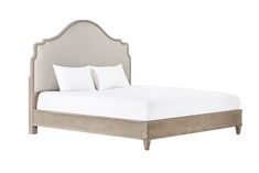 an upholstered bed with white linens and wood frame, on a white background