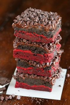 chocolate and red velvet cake stacked on top of each other with oreo chips around the edges