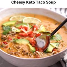 a white bowl filled with taco soup and topped with avocado