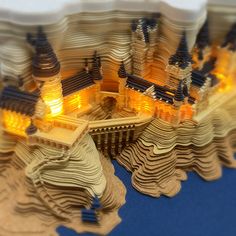 a model of a city with buildings and lights on top of the building is made out of cardboard