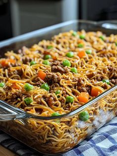 a glass casserole dish filled with noodles and ground beef