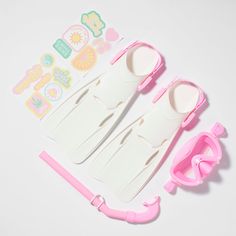 two plastic utensils with pink handles next to each other on a white surface