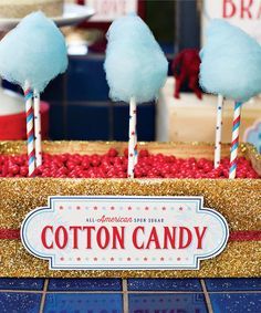 cotton candy sticks in a box with red, white and blue lollipops