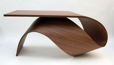 a wooden table with curved legs and a wood surface on the top, against a white background