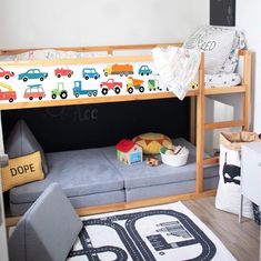 a child's bedroom with a bunk bed and toy cars on the mattresses