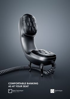 a black chair sitting on top of a table next to an old telephone cord with the words comfortable banking as at your seat