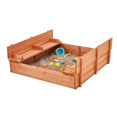 a wooden sandbox with toys in it