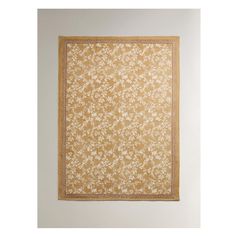 a beige and white rug hanging on the wall