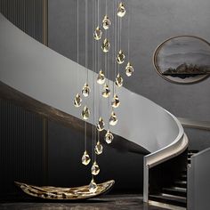 a chandelier hanging from the side of a stair case in a modern home