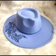 This Blue Western/ Boho Hat Features Florals On The Brim And A Feather Tucked To The Side Of The Blue Velvet Ribbon Hat Band. S/M Polyester Trendy Blue Brimmed Fedora, Blue Spring Felt Hat With Curved Brim, Casual Blue Fedora With Wide Brim, Adjustable Wide Brim Blue Felt Hat, Adjustable Blue Felt Hat With Curved Brim, Adjustable Blue Wide Brim Felt Hat, Trendy Adjustable Blue Fedora, Casual Blue Fedora Hat, Trendy Blue Wide Brim Hat