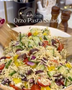 a white bowl filled with pasta salad on top of a table