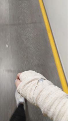 a person with cast on their arm walking down the street