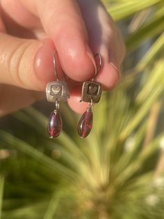 Cute vintage pair of earrings, these are made with sterling silver and Garnet gemstones. Please see photos for approximate measurements. The back of these are marked FF for the maker of the earrings. Garnet Earrings, The Maker, Sunset Beach, Garnet Gemstone, Vintage Sterling Silver, Favorite Jewelry, Garnet, Jewelry Earrings Dangle, Dangle Drop Earrings