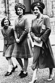 three women in dresses and hats standing next to each other