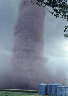 a large tornado cloud is seen in the sky