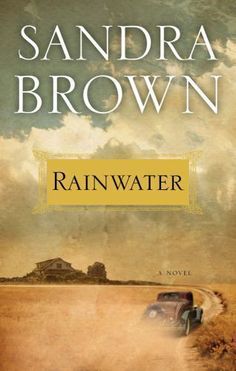 the cover of rainwater by sandra brown, with an image of a car driving down