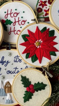 embroidered christmas ornaments hanging on a tree branch with the words merry to all and poinsettis