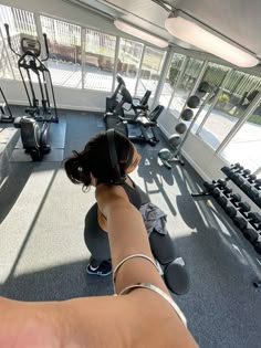 a woman is doing exercises in the gym