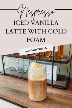 iced vanilla latte with cold foam in a mason jar on top of a counter