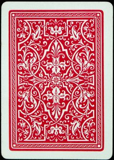 a red and white playing card with an ornate design