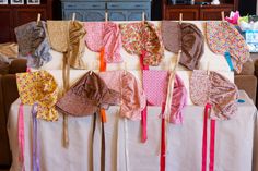 many different types of bras hanging on clothes line in front of couches and coffee table