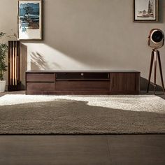 a living room scene with focus on the entertainment center and floor lamp in the foreground