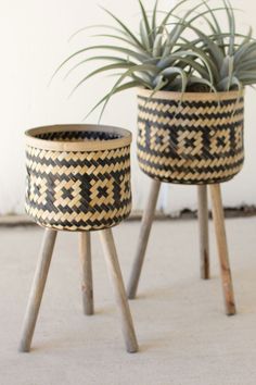 two planters sitting on top of wooden legs